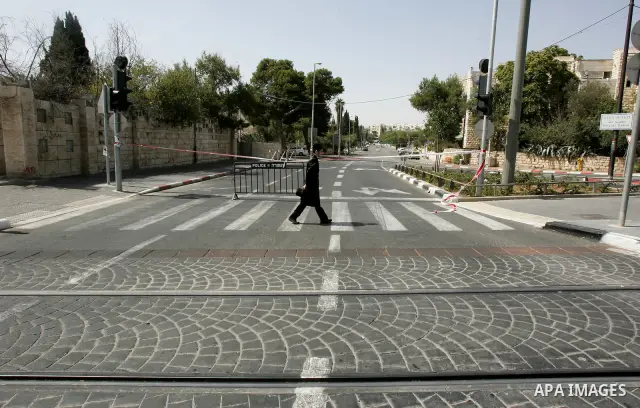 Israelis walks in the middle of an empty street during the Jewish holiday of Yom Kippur in Jerusalem, Saturday, Oct. 8, 2011. Yom Kippur, or "Day of Atonement," is the holiest of Jewish holidays when observant Jews atone...