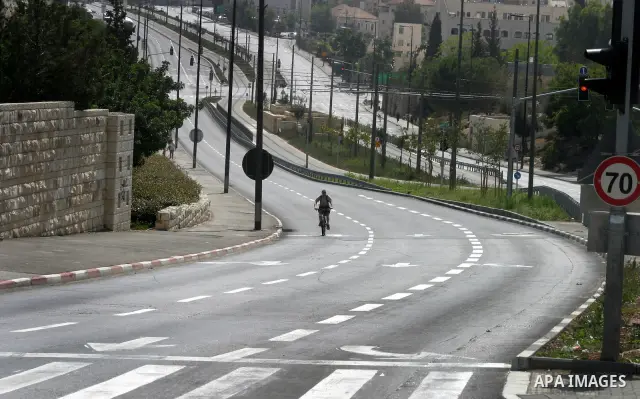 Israelis walks in the middle of an empty street during the Jewish holiday of Yom Kippur in Jerusalem, Saturday, Oct. 8, 2011. Yom Kippur, or "Day of Atonement," is the holiest of Jewish holidays when observant Jews atone...