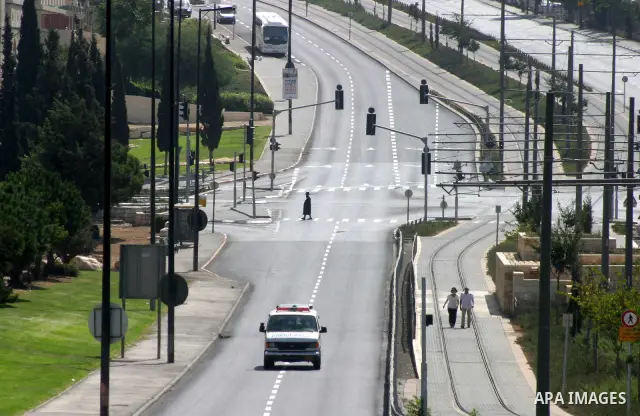 Israelis walks in the middle of an empty street during the Jewish holiday of Yom Kippur in Jerusalem, Saturday, Oct. 8, 2011. Yom Kippur, or "Day of Atonement," is the holiest of Jewish holidays when observant Jews atone...