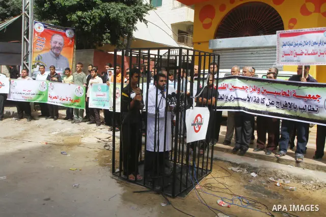 Palestinians take part in a protest in Gaza City Oct, 08, 2011, to show solidarity with Palestinian prisoners held in Israeli jails. Hundreds of Palestinians in Israeli jails have joined a hunger strike to protest agains...