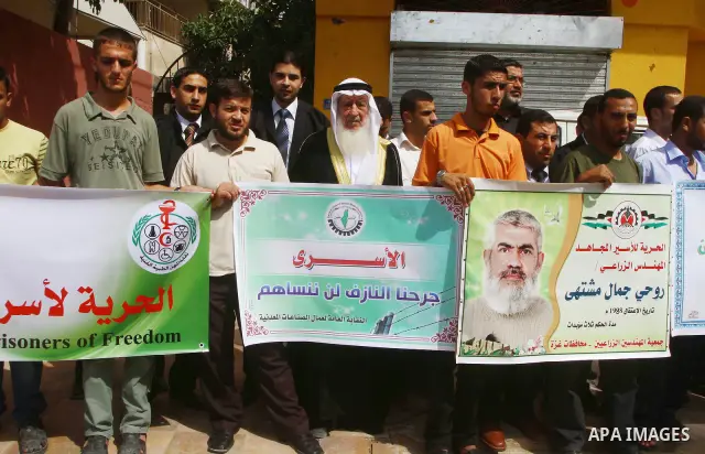 Palestinians take part in a protest in Gaza City Oct, 08, 2011, to show solidarity with Palestinian prisoners held in Israeli jails. Hundreds of Palestinians in Israeli jails have joined a hunger strike to protest agains...