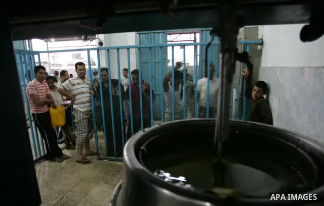 Palestinian men work in an olive oil factory during the olive harvest season , in Khan Yunis in the southern Gaza Strip on October 8, 2011. Palestinians began the annual harvest of olives, a staple for many local farmers...
