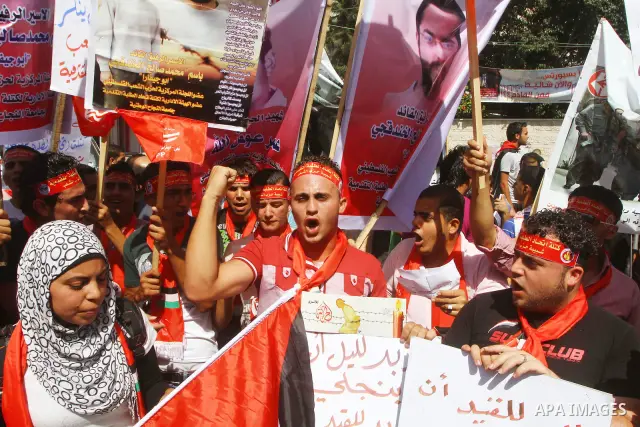 Palestinians shout during a demonstration calling for the release of prisoners from Israeli jails and in support of inmates on a hunger strike, on Oct,09, 2011, in Gaza City. Hundreds of Palestinians in Israeli jails hav...