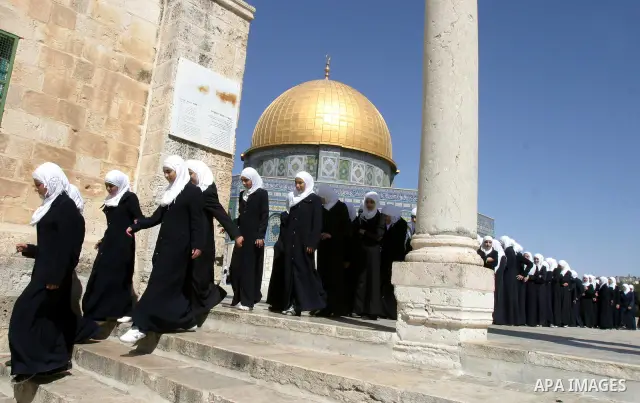 Palestinian schoolgirls walk in front of the Dome of the Rock at Al-Aqsa mosque compound in Jerusalem's old city on Oct. 9,2011. Israel limited access to Jerusalem's Al-Aqsa mosque compound for fear of violence during Yo...