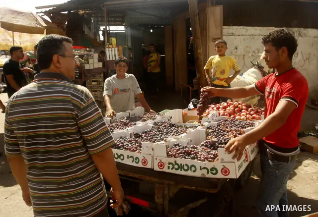 Palestinians shop at the old Fras market in Gaza city on Oct. 9,2011. A Palestinian investor rented Fras from the government in Gaza Strip to establish a large mall instead of the old market which oppose with refuse and...