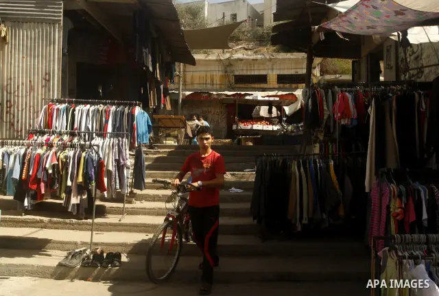 Palestinians shop at the old Fras market in Gaza city on Oct. 9,2011. A Palestinian investor rented Fras from the government in Gaza Strip to establish a large mall instead of the old market which oppose with refuse and...
