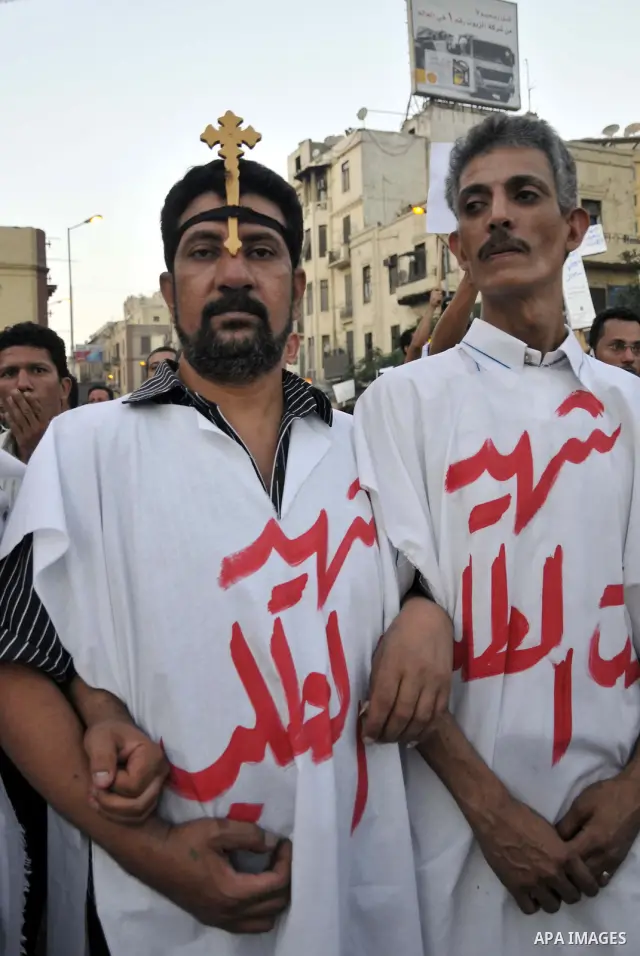 Egyptian Coptic Christians hold crosses and shout slogans, during a protest in Shubra, Cairo, 09 October 2011. According to media report, hundreds of Coptic Christians on 09 October, demonstrated outside the state televi...