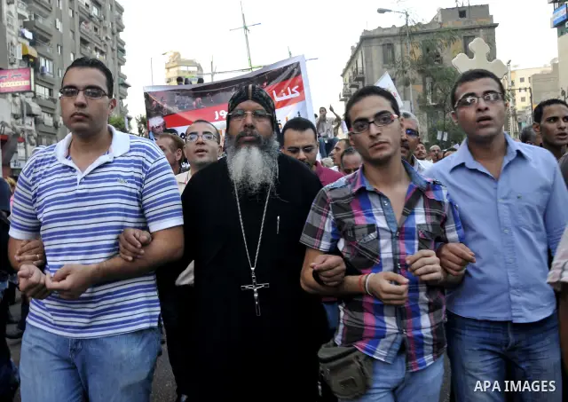 Egyptian Coptic Christians hold crosses and shout slogans, during a protest in Shubra, Cairo, 09 October 2011. According to media report, hundreds of Coptic Christians on 09 October, demonstrated outside the state televi...