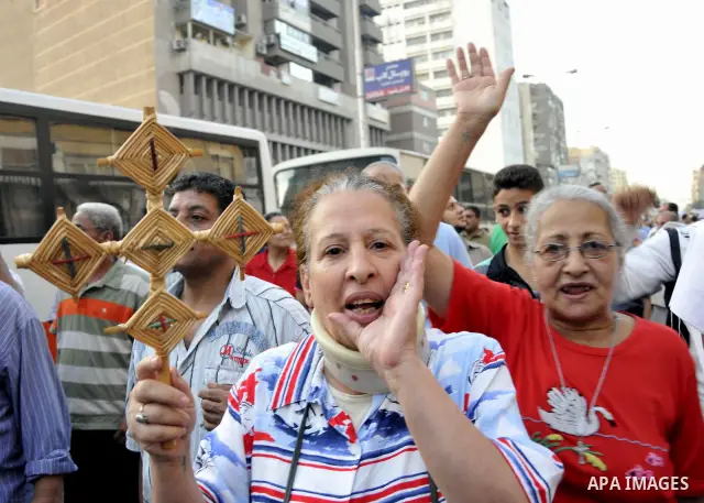 Egyptian Coptic Christians hold crosses and shout slogans, during a protest in Shubra, Cairo, 09 October 2011. According to media report, hundreds of Coptic Christians on 09 October, demonstrated outside the state televi...
