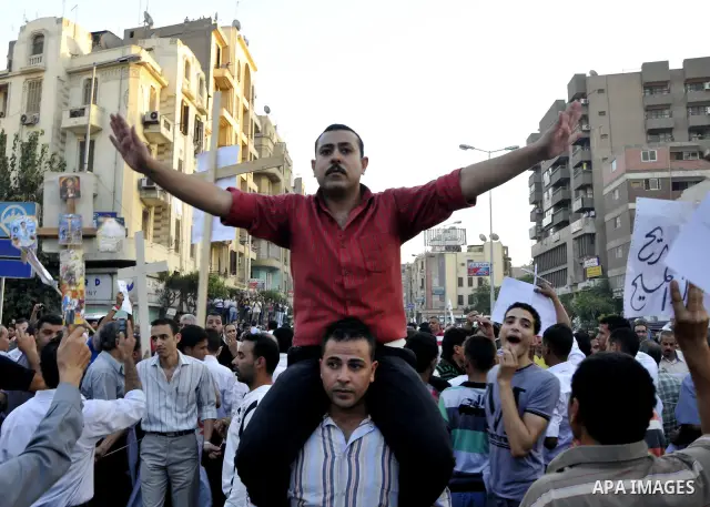 Egyptian Coptic Christians hold crosses and shout slogans, during a protest in Shubra, Cairo, 09 October 2011. According to media report, hundreds of Coptic Christians on 09 October, demonstrated outside the state televi...