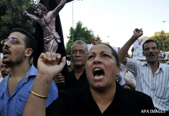 Egyptian Coptic Christians hold crosses and shout slogans, during a protest in Shubra, Cairo, 09 October 2011. According to media report, hundreds of Coptic Christians on 09 October, demonstrated outside the state televi...