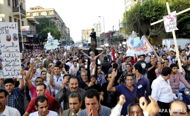 Egyptian Coptic Christians hold crosses and shout slogans, during a protest in Shubra, Cairo, 09 October 2011. According to media report, hundreds of Coptic Christians on 09 October, demonstrated outside the state televi...
