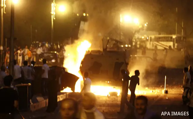 Coptic Egyptian demonstrators gather by a burning army vehicle during cashes with Egyptian Army soldiers following a demonstration in Cairo, Egypt Sunday, Oct. 9, 2011. Egyptian state television reports at least one sold...