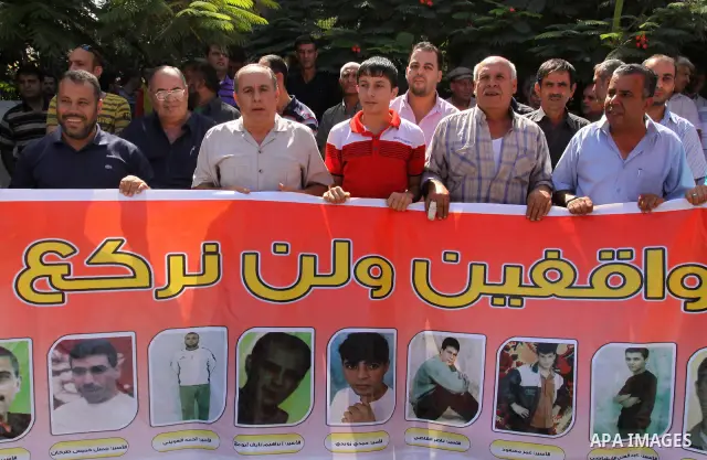 Palestinians protest during a demonstration calling for the release of prisoners from Israeli jails and in support of inmates on a hunger strike, on October 10, 2011, in Gaza City. Hundreds of Palestinians in Israeli jai...