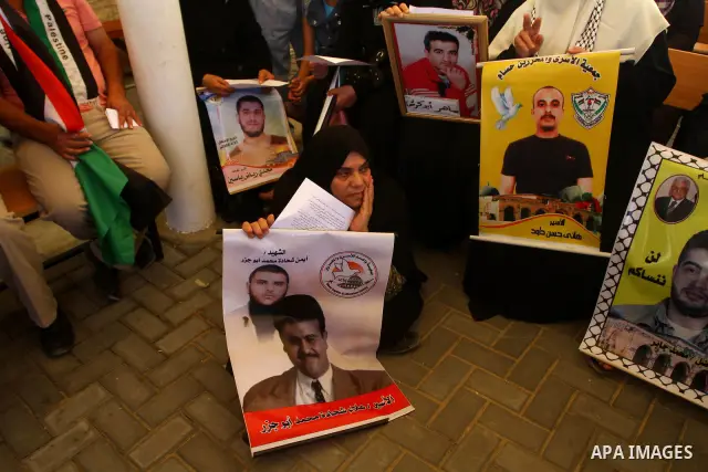 Palestinians take part in a protest in solidarity with Palestinian prisoners held in Israeli jails, in front of the International Red Cross building in Gaza City, Monday, Oct. 10, 2011. Gaza's Hamas rulers have imposed n...