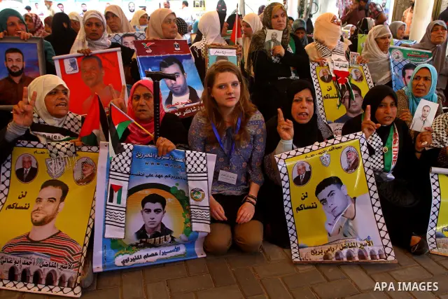 Palestinians take part in a protest in solidarity with Palestinian prisoners held in Israeli jails, in front of the International Red Cross building in Gaza City, Monday, Oct. 10, 2011. Gaza's Hamas rulers have imposed n...