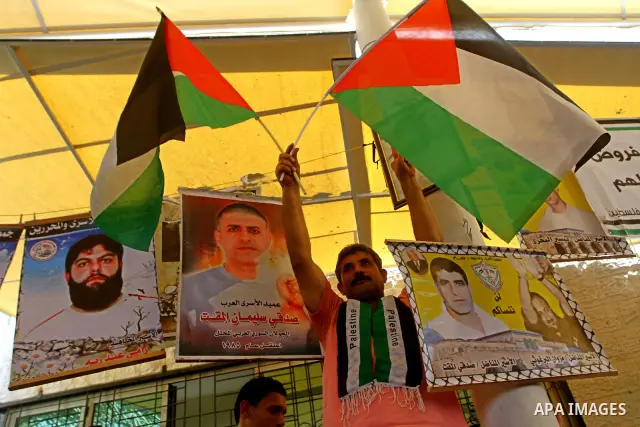 Palestinians take part in a protest in solidarity with Palestinian prisoners held in Israeli jails, in front of the International Red Cross building in Gaza City, Monday, Oct. 10, 2011. Gaza's Hamas rulers have imposed n...