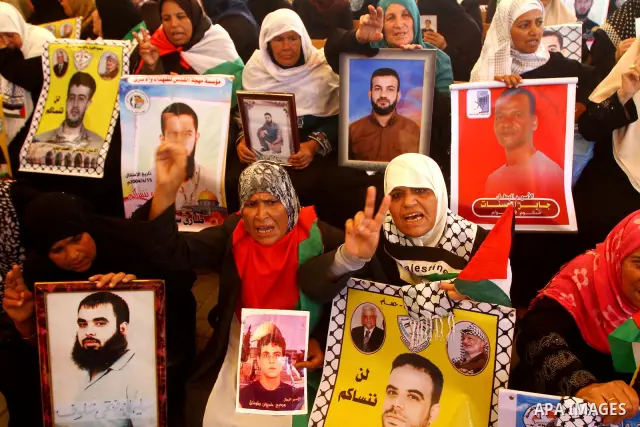 Palestinians take part in a protest in solidarity with Palestinian prisoners held in Israeli jails, in front of the International Red Cross building in Gaza City, Monday, Oct. 10, 2011. Gaza's Hamas rulers have imposed n...