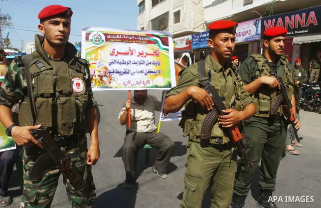 Palestinians take part in a protest in solidarity with Palestinian prisoners held in Israeli jails, in front of the International Red Cross building in Gaza City, Monday, Oct. 10, 2011. Gaza's Hamas rulers have imposed n...