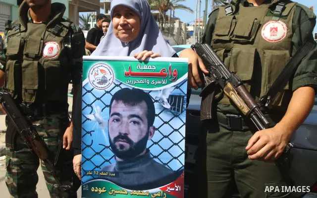 Palestinians take part in a protest in solidarity with Palestinian prisoners held in Israeli jails, in front of the International Red Cross building in Gaza City, Monday, Oct. 10, 2011. Gaza's Hamas rulers have imposed n...