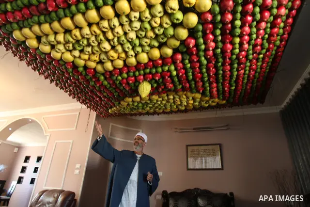 A man from the ancient Samaritan community decorates a Sukkah made from fresh fruit for the holiday of the Tabernacles, or Sukkot, in Mount Gerizim near the West Bank town of Nablus, Monday, Oct. 10, 2011. The Sukkah is...