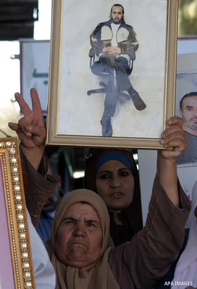 Palestinians take part in a protest in solidarity with their relatives Palestinian prisoners held in Israeli jails in a protest tent in front of the Red Cross' offices in east Jerusalem, on October 10, 2011. Thousands of...