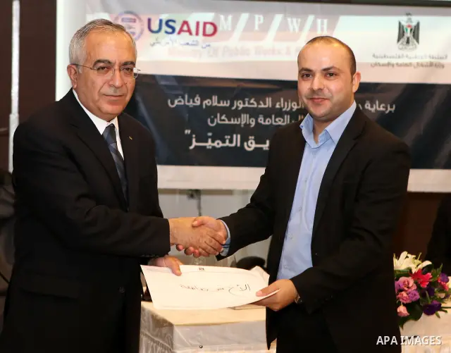 Palestinian prime minister Salam Fayyad attends a celebration to honor the staff of the Ministry of Public Works in the West Bank city of Ramallah, on October 10, 2011. Photo by Mustafa Abu Dayeh