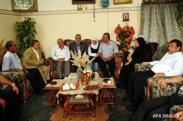 Palestinian prime minister in Gaza Strip, Ismail Haniya visits the family of Osama Awad, who killed during a training session, in Gaza city on Oct. 10,2011. Photo by Ahmed Shaat