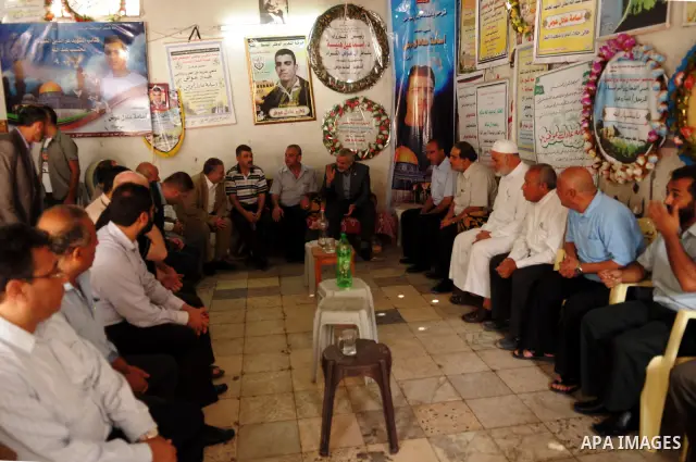 Palestinian prime minister in Gaza Strip, Ismail Haniya visits the family of Osama Awad, who killed during a training session, in Gaza city on Oct. 10,2011. Photo by Ahmed Shaat