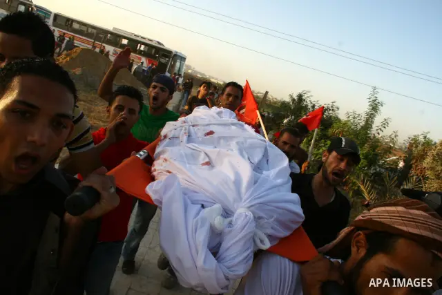 Palestinian mourners carry the body of Ahmed Azazmeh, killed in an explosion, during his funeral in Beit Hanoun, near the Erez Crossing between Gaza Strip and Israel, Monday, Oct. 10, 2011. Palestinian officials in the G...
