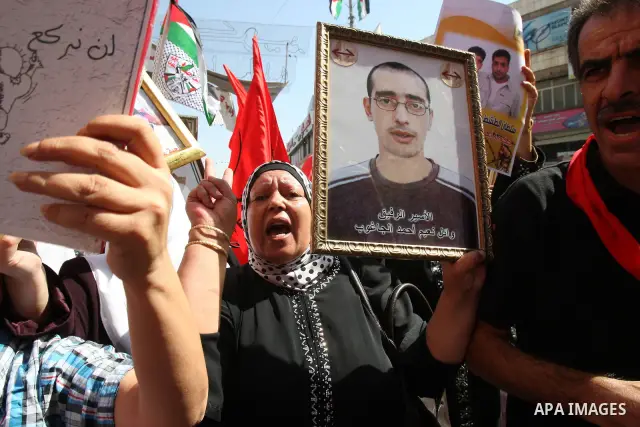 Palestinians participate in a demonstration in solidarity with prisoners jailed in Israel, in the West Bank city of Nablus, Oct. 11, 2011. According to the Israeli Prison Service spokesman, over 200 Palestinian prisoners...