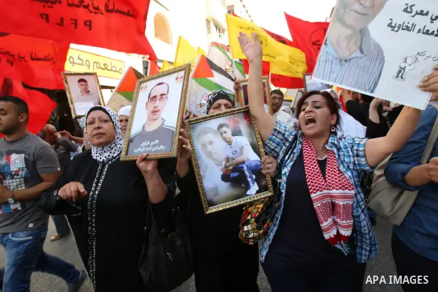 Palestinians participate in a demonstration in solidarity with prisoners jailed in Israel, in the West Bank city of Nablus, Oct. 11, 2011. According to the Israeli Prison Service spokesman, over 200 Palestinian prisoners...