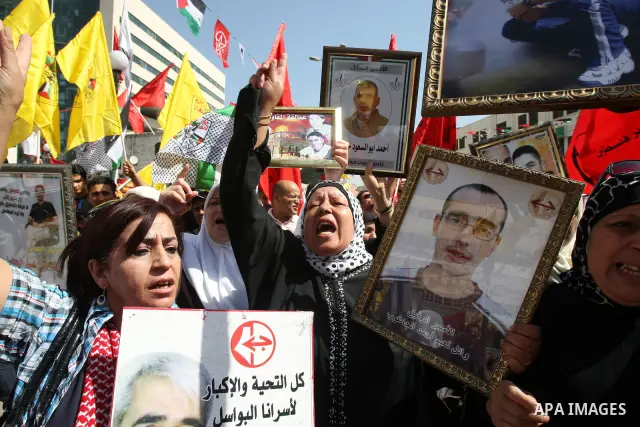 Palestinians participate in a demonstration in solidarity with prisoners jailed in Israel, in the West Bank city of Nablus, Oct. 11, 2011. According to the Israeli Prison Service spokesman, over 200 Palestinian prisoners...