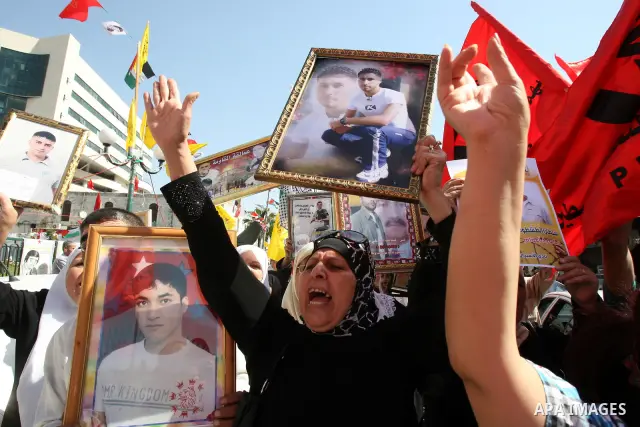 Palestinians participate in a demonstration in solidarity with prisoners jailed in Israel, in the West Bank city of Nablus, Oct. 11, 2011. According to the Israeli Prison Service spokesman, over 200 Palestinian prisoners...