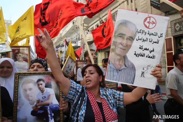 Palestinians participate in a demonstration in solidarity with prisoners jailed in Israel, in the West Bank city of Nablus, Oct. 11, 2011. According to the Israeli Prison Service spokesman, over 200 Palestinian prisoners...
