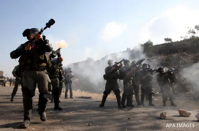 Israeli forces clash with Palestinian protestors following a demonstration calling for the release of prisoners held in Israeli jails and in support of inmates in hunger strike, on October 11, 2011 near Israel's Ofer pri...