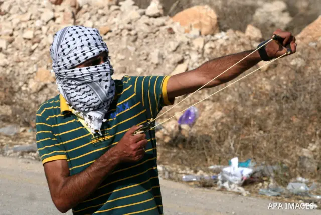 A Palestinian protestor clashes with Israeli forces following a demonstration calling for the release of prisoners held in Israeli jails and in support of inmates in hunger strike, on October 11, 2011 near Israel's Ofer...