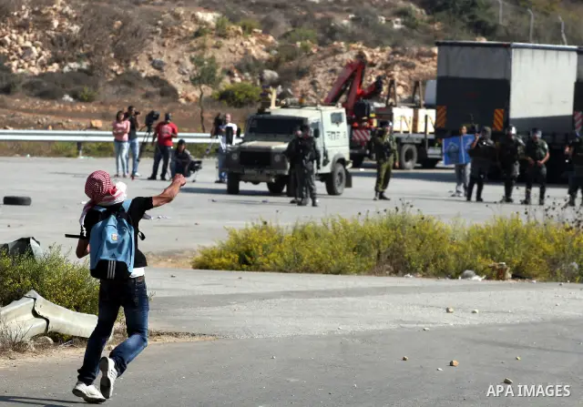 A Palestinian protestor clashes with Israeli forces following a demonstration calling for the release of prisoners held in Israeli jails and in support of inmates in hunger strike, on October 11, 2011 near Israel's Ofer...