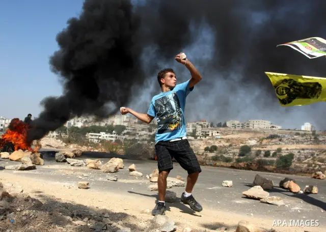 A Palestinian protestor clashes with Israeli forces following a demonstration calling for the release of prisoners held in Israeli jails and in support of inmates in hunger strike, on October 11, 2011 near Israel's Ofer...