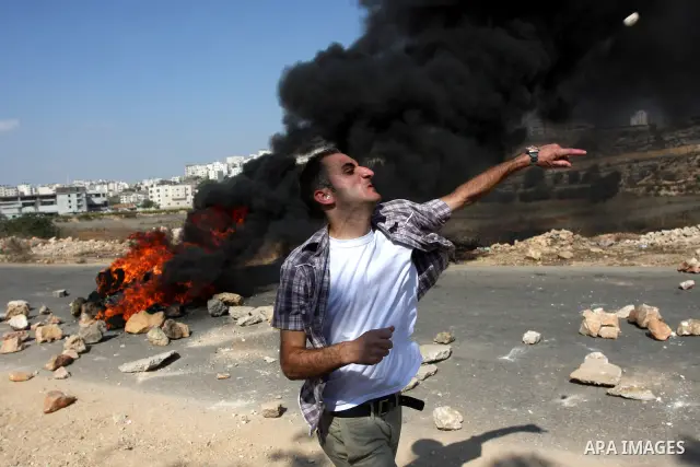 A Palestinian protestor clashes with Israeli forces following a demonstration calling for the release of prisoners held in Israeli jails and in support of inmates in hunger strike, on October 11, 2011 near Israel's Ofer...