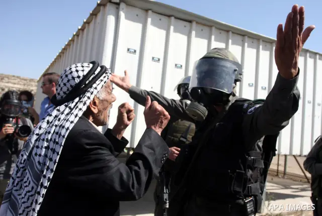 An Israeli soldier argues with a Palestinian man during a demonstration calling for the release of prisoners held in Israeli jails and in support of inmates in hunger strike, on October 11, 2011 near Israel's Ofer prison...