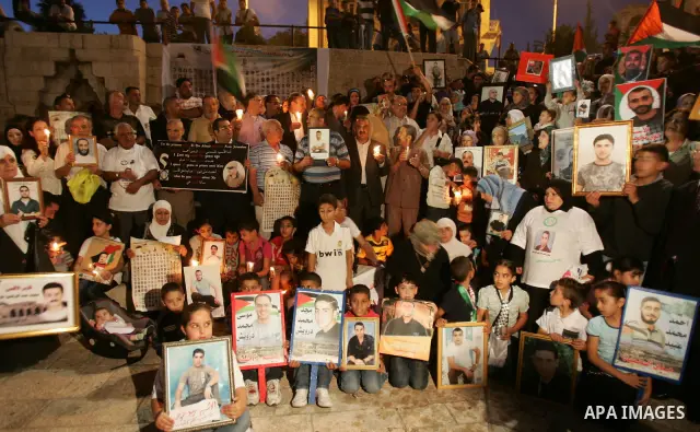 Palestinians take part in a protest calling for the release of Palestinian prisoners from Israeli jails and in support of inmates in hunger strike on October 11, 2011 outside Damascus Gate in Jerusalem's Old City. Accord...