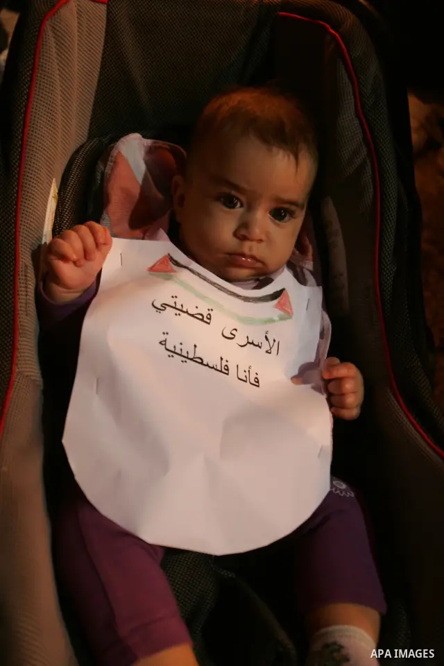A Palestinian boy take part in a protest calling for the release of Palestinian prisoners from Israeli jails and in support of inmates in hunger strike on October 11, 2011 outside Damascus Gate in Jerusalem's Old City. A...