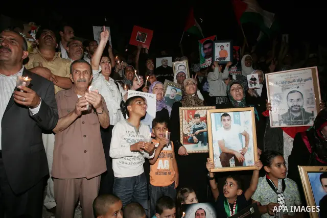 Palestinians take part in a protest calling for the release of Palestinian prisoners from Israeli jails and in support of inmates in hunger strike on October 11, 2011 outside Damascus Gate in Jerusalem's Old City. Accord...