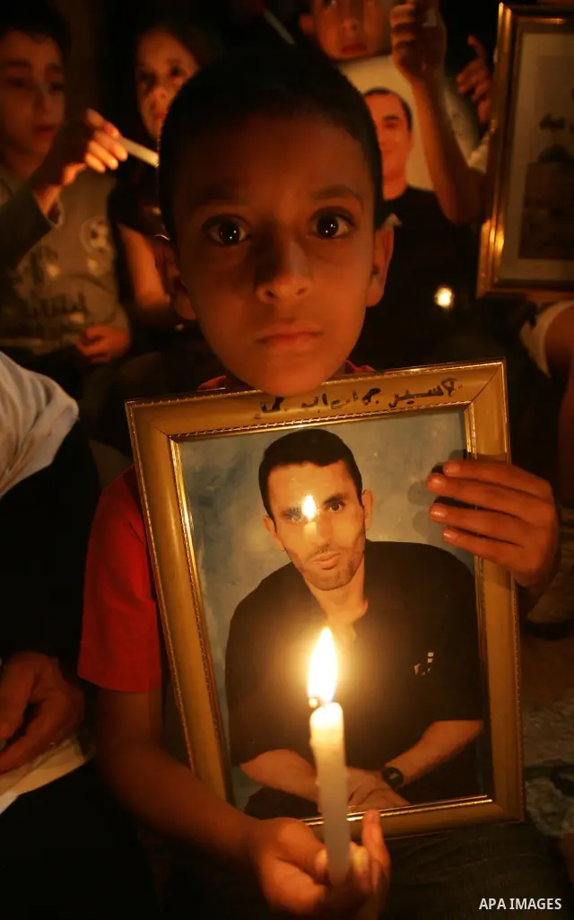 A Palestinian boy take part in a protest calling for the release of Palestinian prisoners from Israeli jails and in support of inmates in hunger strike on October 11, 2011 outside Damascus Gate in Jerusalem's Old City. A...