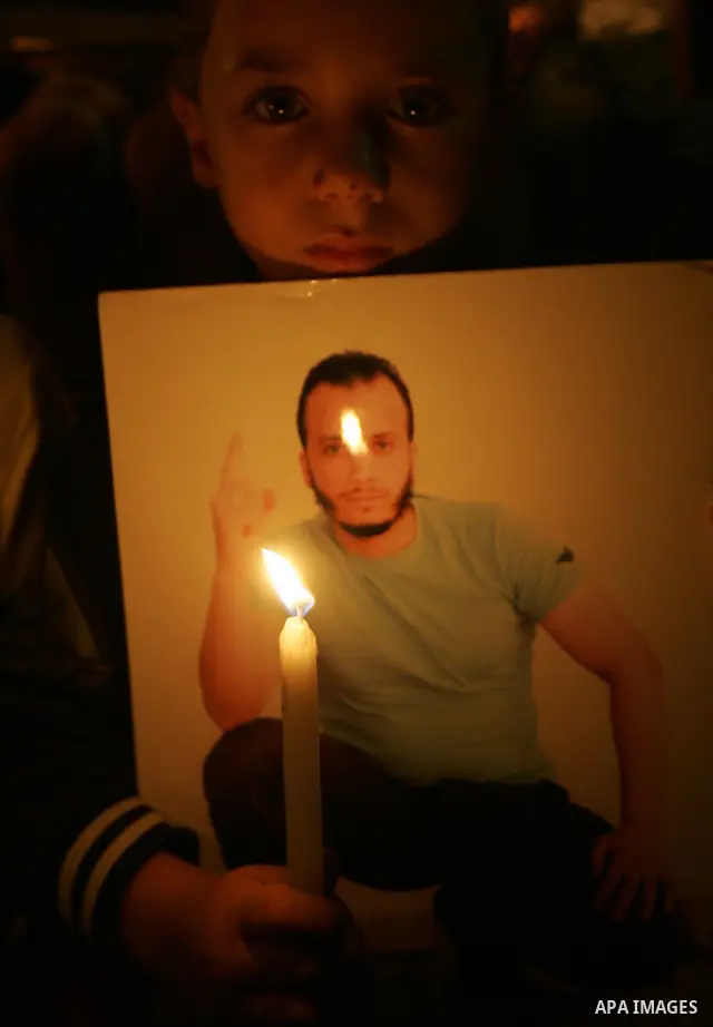 A Palestinian boy take part in a protest calling for the release of Palestinian prisoners from Israeli jails and in support of inmates in hunger strike on October 11, 2011 outside Damascus Gate in Jerusalem's Old City. A...