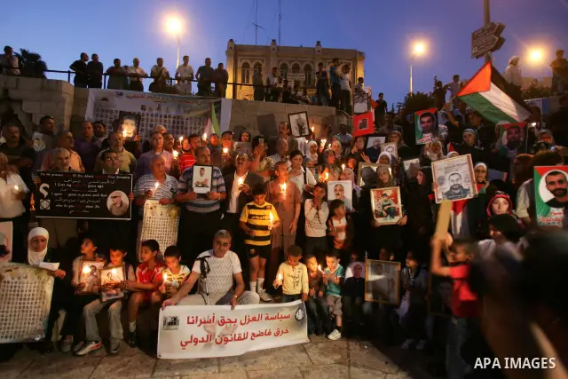 Palestinians take part in a protest calling for the release of Palestinian prisoners from Israeli jails and in support of inmates in hunger strike on October 11, 2011 outside Damascus Gate in Jerusalem's Old City. Both t...