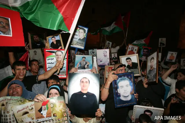 Palestinians take part in a protest calling for the release of Palestinian prisoners from Israeli jails and in support of inmates in hunger strike on October 11, 2011 outside Damascus Gate in Jerusalem's Old City. Both t...