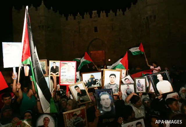 Palestinians take part in a protest calling for the release of Palestinian prisoners from Israeli jails and in support of inmates in hunger strike on October 11, 2011 outside Damascus Gate in Jerusalem's Old City. Both t...