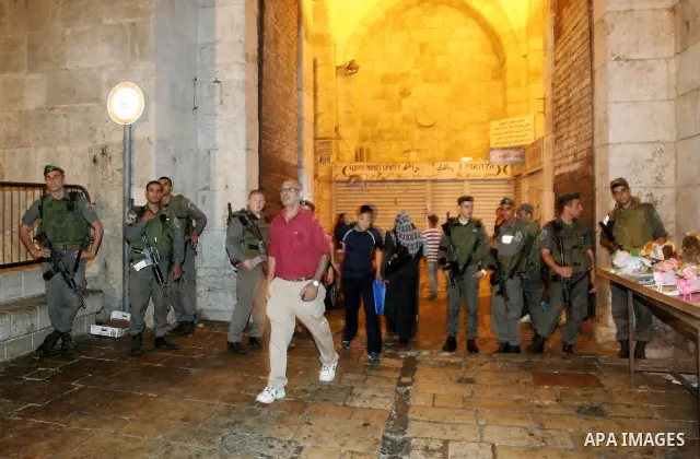 Israeli soldiers stand guard as Palestinians take part in a protest calling for the release of Palestinian prisoners from Israeli jails and in support of inmates in hunger strike on October 11, 2011 outside Damascus Gate...